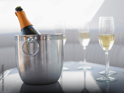 Flutes With Champagne Bottle In Ice Bucket