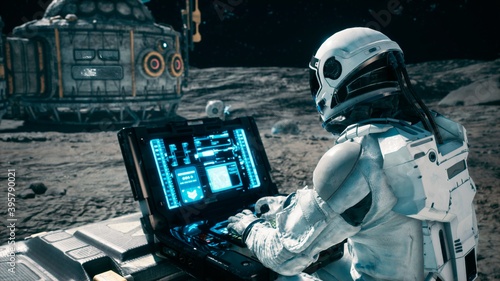Billede på lærred An astronaut works on his laptop at a space base on one of the new planets