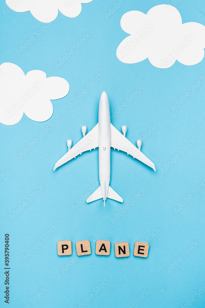 top view of airplane model and cubes with word plane on blue sky top view of airplane model and cubes with word plane on blue sky