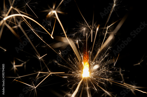 Extreme close-up of a burning sparkler with black background