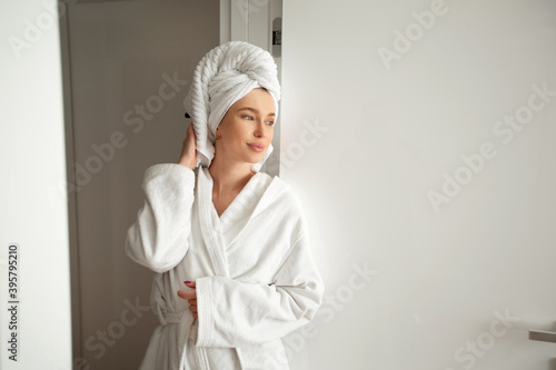 beautiful young woman in a white robe in the interior