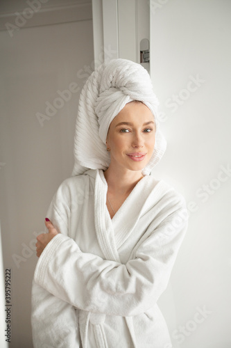 beautiful young woman in a white robe in the interior