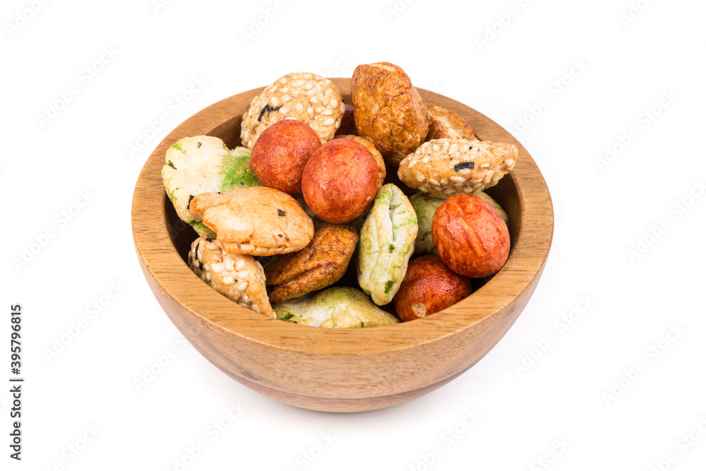 Fototapeta premium Green red and orange oriental snack mix in a bowl isolated over white