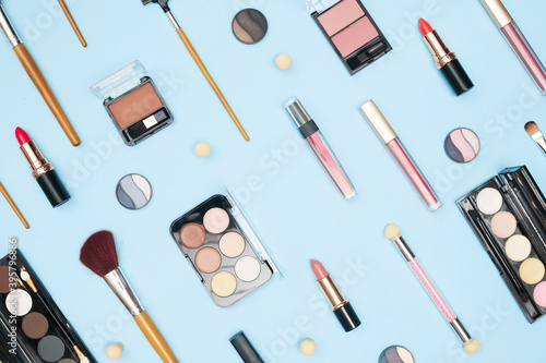 set of professional cosmetics, makeup tools and accessories on blue background, beauty, fashion, shopping concept, flat la