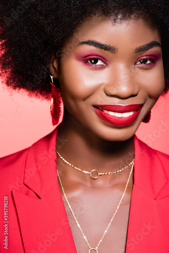  african american young woman in stylish outfit isolated on red