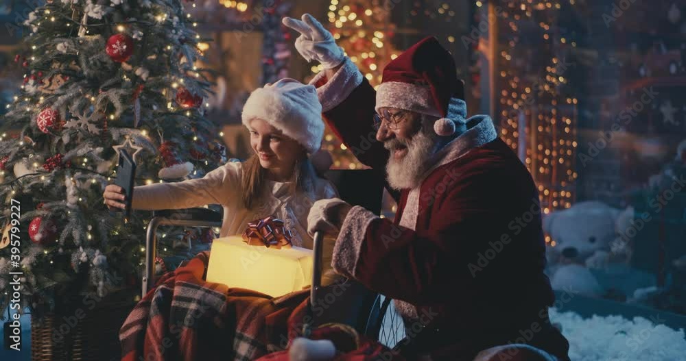 Handicapped girl taking selfie with Santa Claus Handicapped girl taking selfie with Santa Claus