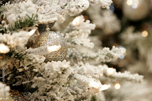Close-up of Christmas tree decoration with white  silver and bronze shades. Christmas and New Year decorated interior