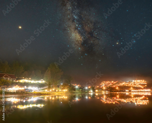 Light ambient with the milky way at "Ban Rak Thai village" in the night beside the beautiful lake, a Village is travel destination in Mae Hong Son province, Thailand. 