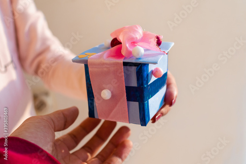 Happy birthday! Close up of woman giving present to best friend. Holiday gift concept with copy space