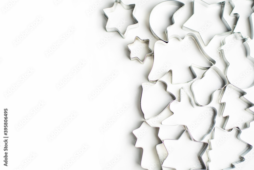 Fototapeta premium Forms for cookies and gingerbread on a white background lie on the right, place for text on the left