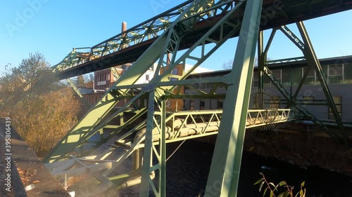 metalic construction rail for suspended train over water in a german post industrial city, and smoke