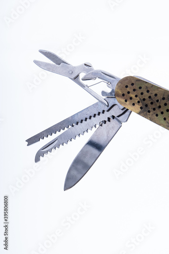 Multi-tool pocket folding with a camouflage pattern. Isolated with white background photo