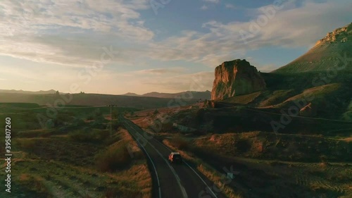 car traveling at sunset at a cinematic landscape