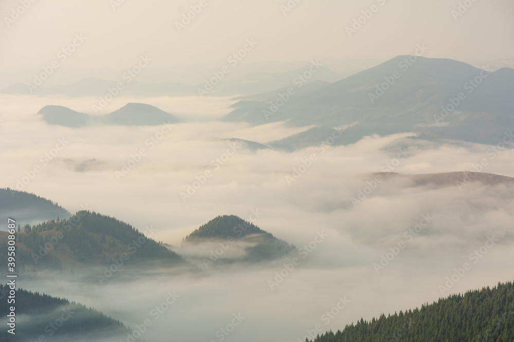 Beautiful sunrise in the Carpathian mountains with fog and dramatic sky