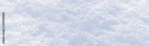 White snow winter texture. Christmas holiday background. Seasonal fresh snow nature backdrop wallpaper. First frost. Crisp sparkling textured ice frosty snow outdoors. Web banner header.