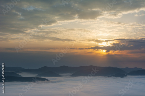 Beautiful sunrise in the Carpathian mountains with fog and dramatic sky © reme80