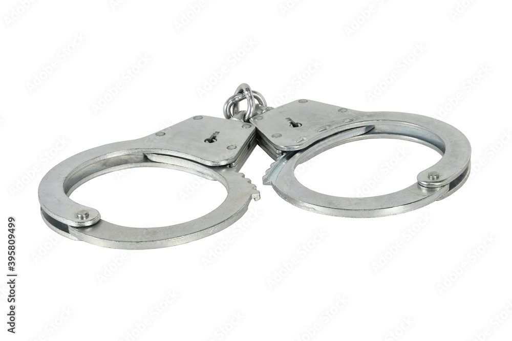 Handcuffs isolated on white background without shadows. Pair of silver handcuffs macro close-up high resolution. Handcuffs isolated on white background without shadows. Pair of silver handcuffs macro close-up high resolution.