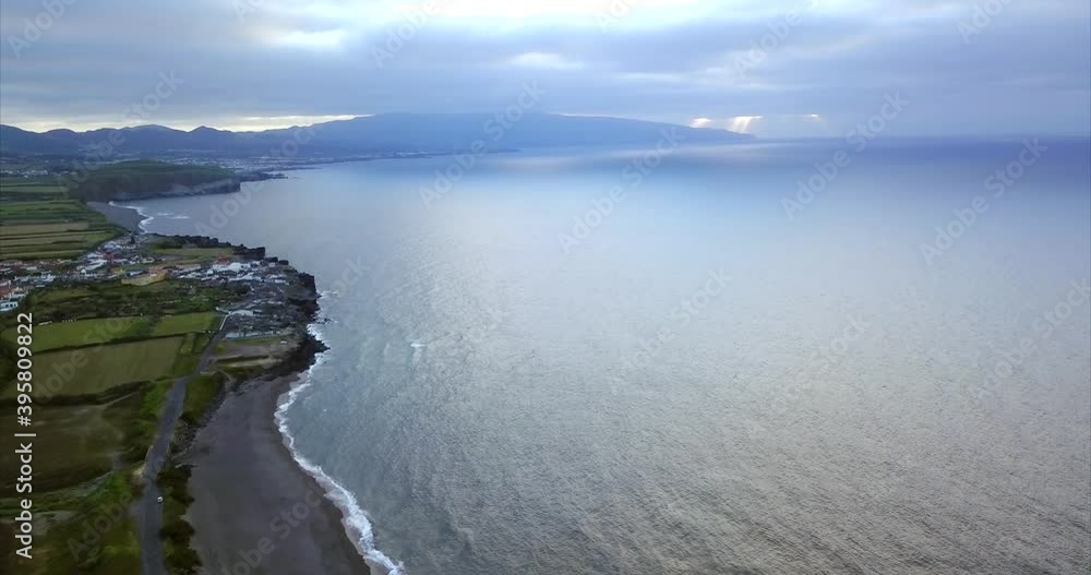 Aerial view over the Ribeira Grande Shore in the North Coast of the Island of São Miguel, in typical cloudy day. Azores Islands, Portugal. Aerial view over the Ribeira Grande Shore in the North Coast of the Island of São Miguel, in typical cloudy day. Azores Islands, Portugal.