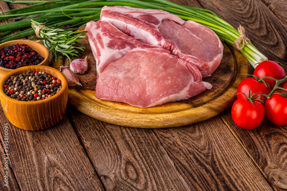 fresh raw new-york steak on wooden Board on wooden background with salt and pepper in a rustic style.