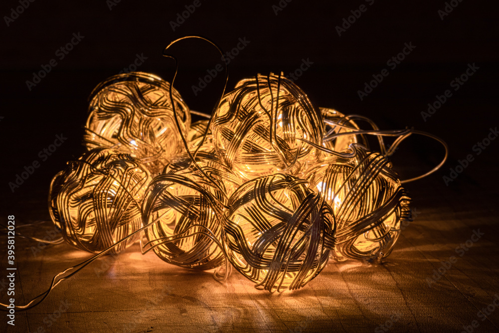 still life of lighted gold metal balls 