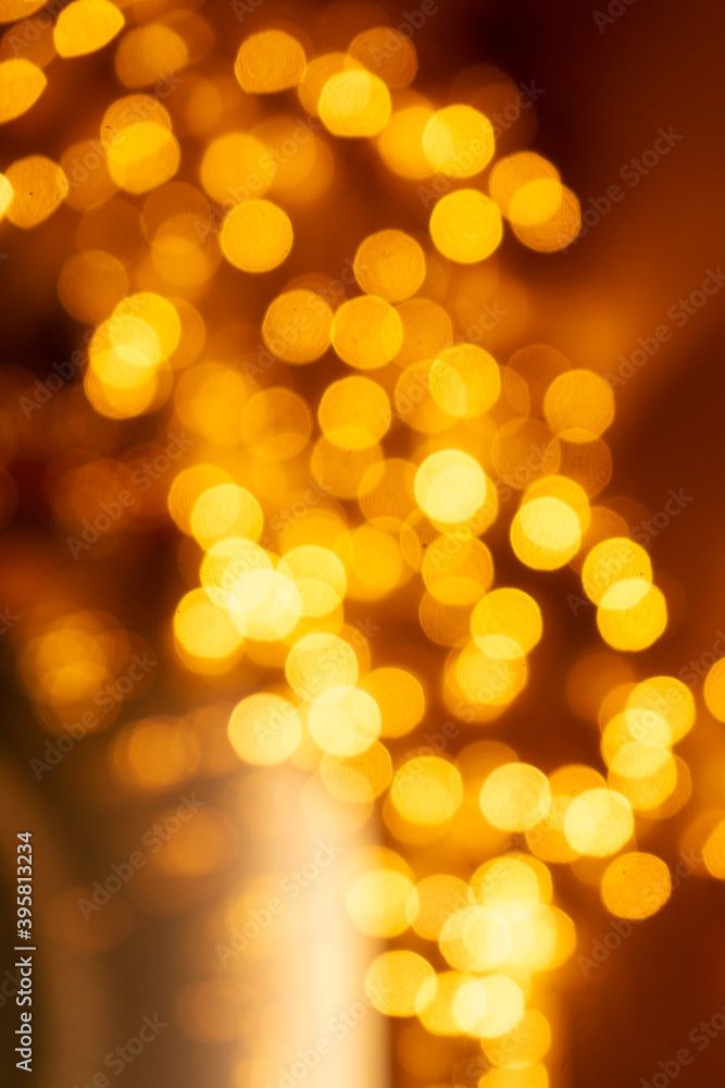Cozy evening in the festive city. Blurred image of shop windows decorated with light garlands for Christmas and New Year celebration. Shining window-shopping at midnight. Abstract holiday background Cozy evening in the festive city. Blurred image of shop windows decorated with light garlands for Christmas and New Year celebration. Shining window-shopping at midnight. Abstract holiday background