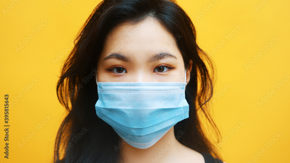Portrait of young asian woman with medical mask. Protection against covid-19 spread. High quality photo Portrait of young asian woman with medical mask. Protection against covid-19 spread. High quality photo