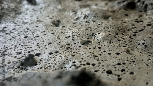 a mixture of cement, water and sand that began to petrify to form small holes