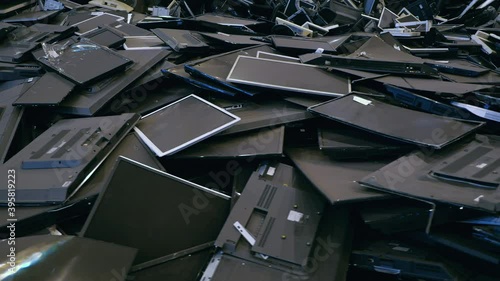 Dump of old monitors, LCD panels and flat-screen TVs. Recycling of electronic waste and plastic scrap. A huge pile of old displays.