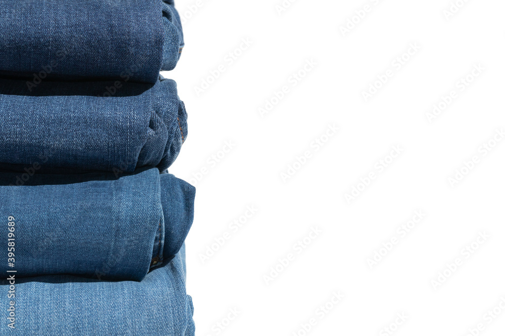 The stack of jeans on white, different shades of blue. Copy space. The stack of jeans on white, different shades of blue. Copy space.