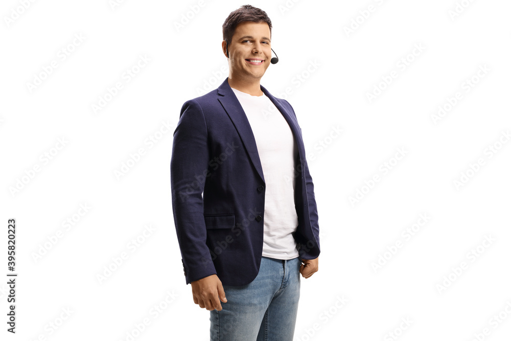 Smiling young man with a wireless microphone looking at the camera Smiling young man with a wireless microphone looking at the camera