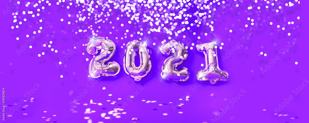 New year 2021 celebration. Gold foil balloons numeral and silver glittering confetti on lilac and purple background New year 2021 celebration. Gold foil balloons numeral and silver glittering confetti on lilac and purple background