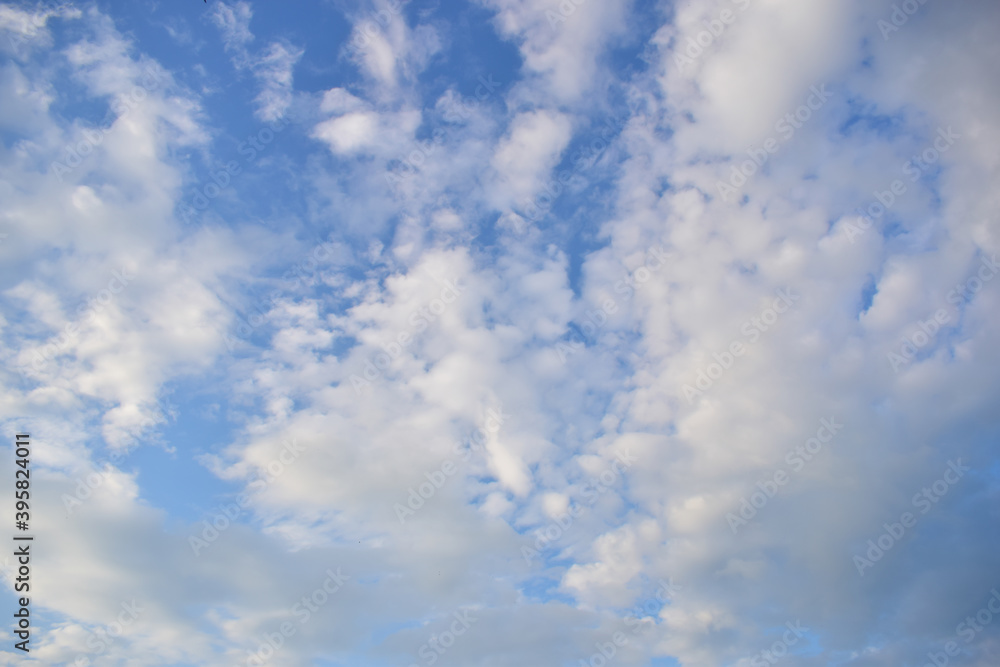 many white clouds float across the blue sky many white clouds float across the blue sky