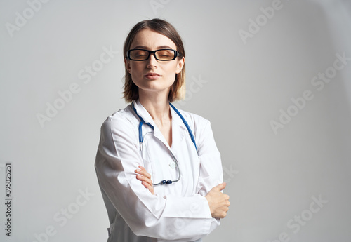 Portrait of a female doctor in a medical gown and a blue stethoscope