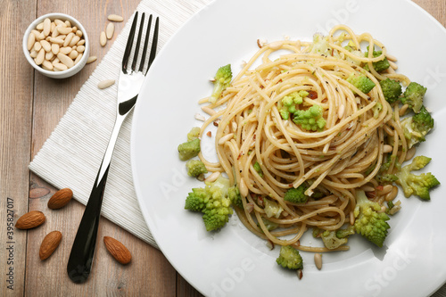 Pasta. Spaghetti with broccoli, almonds, pine nuts, oregano and extra virgin olive oil, top view.