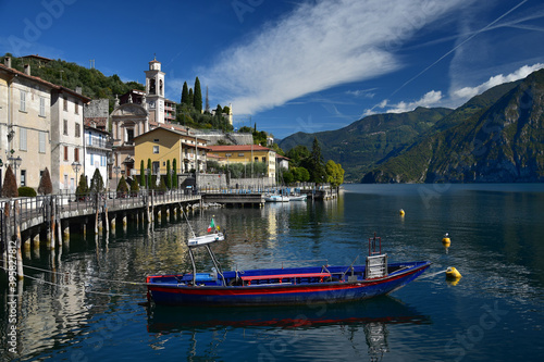 The small town Riva di Solto at Lake Iseo, Lombardy, Italy. A boat in front.
