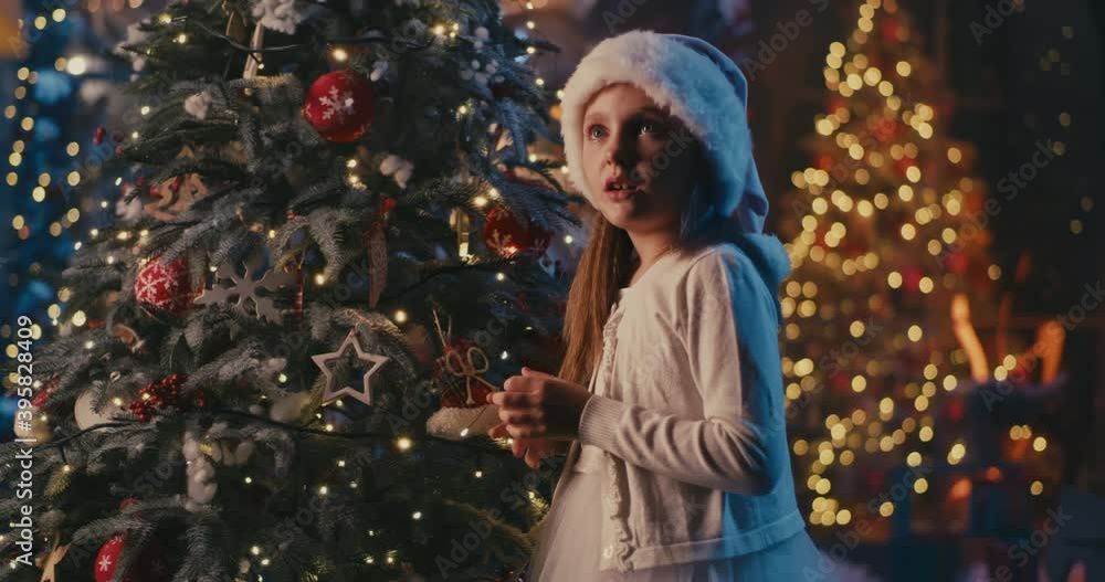 Shocked girl receiving gift from Santa Claus Shocked girl receiving gift from Santa Claus