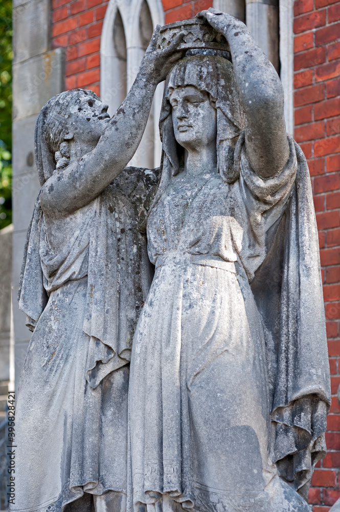 Tomb sculpture of a goddess of the dead removing the crown of life from the woman in Lychakiv, Lviv, Ukraine