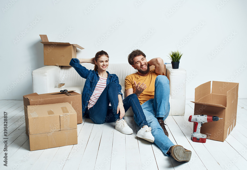 Emotional man and woman with cardboard boxes on the floor having fun moving renovation work Emotional man and woman with cardboard boxes on the floor having fun moving renovation work