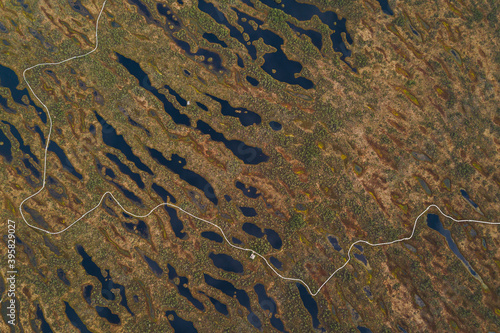 aerial drone shot view look from above of a swamp moss national park in Latvia, Kemeri with a trail and small ponds peat bog turbary photo