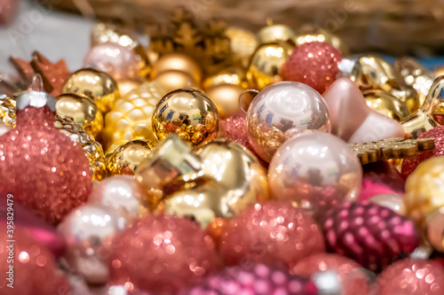 Golden and pink pink Christmas decorations lying around