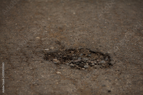 pits and holes in the asphalt road