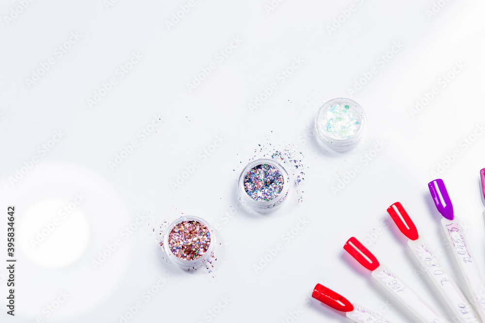 Sequins for nails in a box on a white background. Bright, light. Nail tips collection, salon advertisement. Sequins for nails in a box on a white background. Bright, light. Nail tips collection, salon advertisement.