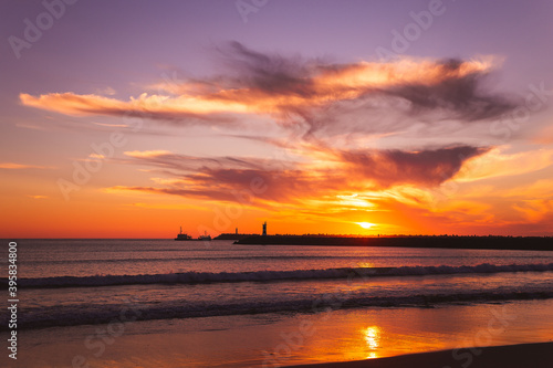sunset on the beach in the Atlantic ocean Viana do Castelo Praia do Cabedelo Cabedelo beach colorful clouds with a lighthouse