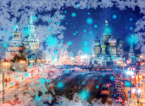 Snowflake New Year winter pattern with white bokeh and spots on blurred defocused background of night illuminated Kremlin © boligolovag