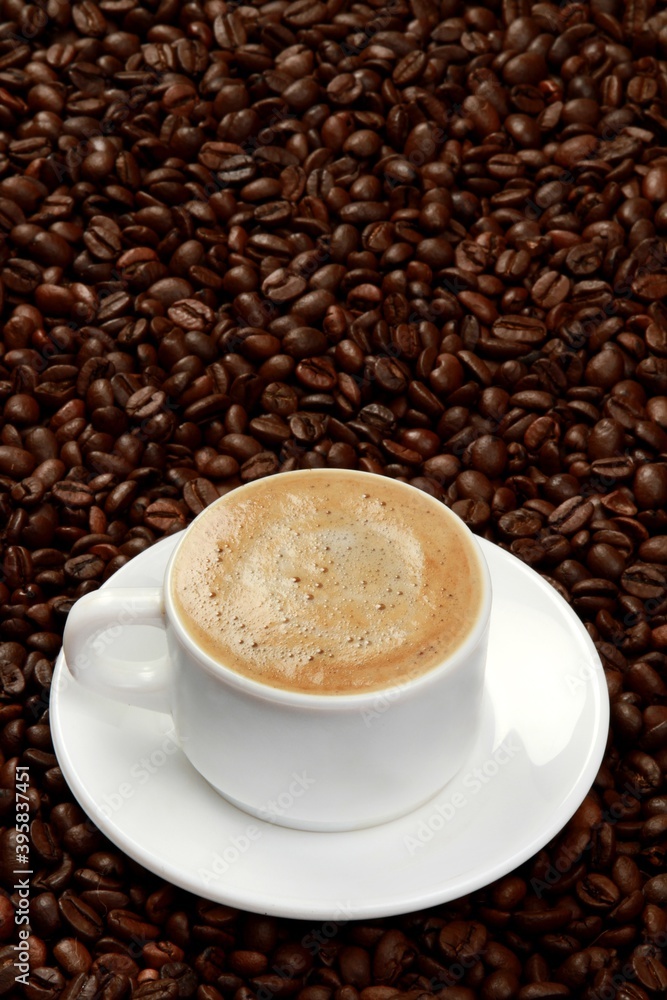 Cup of coffee surrounded by coffee beans Cup of coffee surrounded by coffee beans