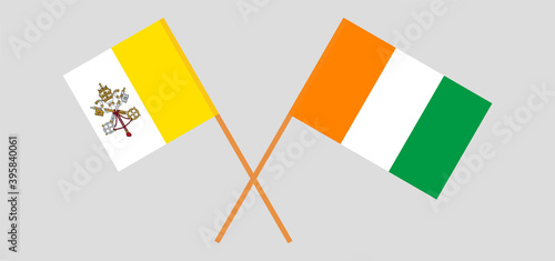 Crossed flags of Vatican and Republic of Ivory Coast