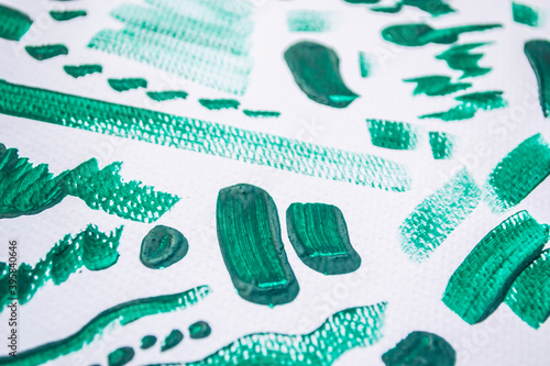 Page of green watercolour squiggles on white watercolour paper