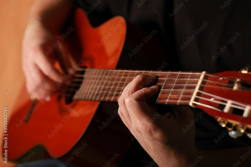 Fototapeta premium Man playing an acoustic guitar