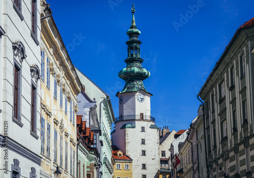 Buildings at Michalska Street with white tower of Michael Gate in historic part of Bratislava city, Slovakia