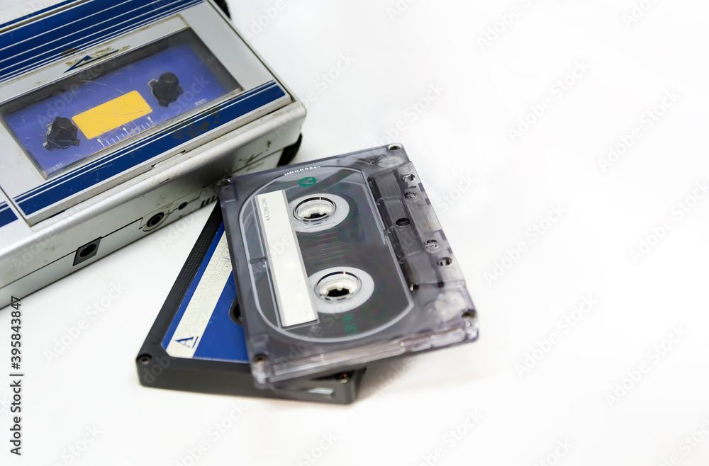Old portable stereo audio tape cassette player isolated on a white background. Obsolete technology. 80s. Listening to music. Old portable stereo audio tape cassette player isolated on a white background. Obsolete technology. 80s. Listening to music.